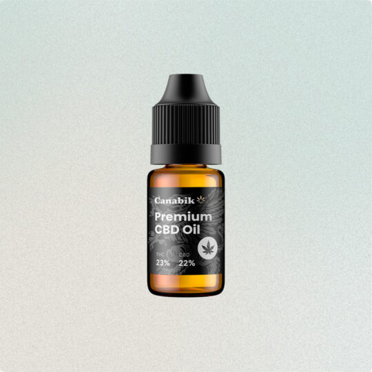 A small bottle of premium hemp oil with a golden liquid inside.